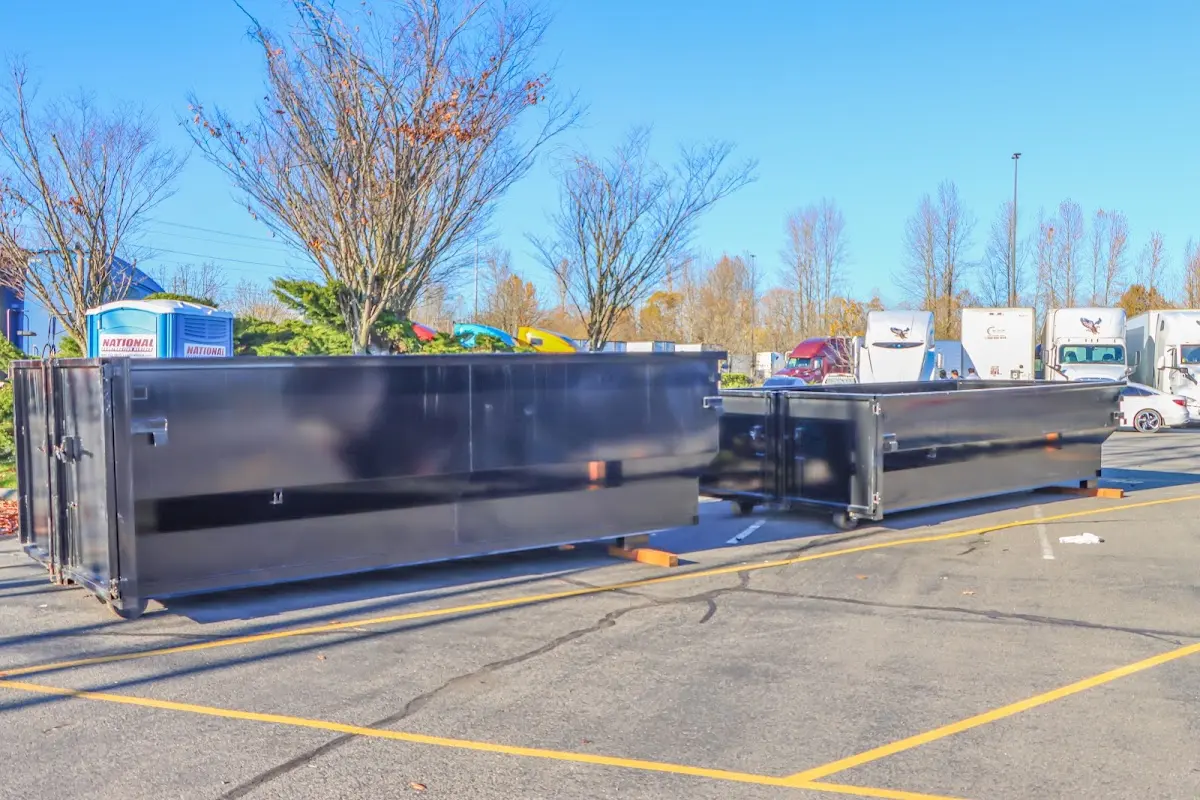 Professional dumpster rental service with roll-off container on residential driveway in Griswold